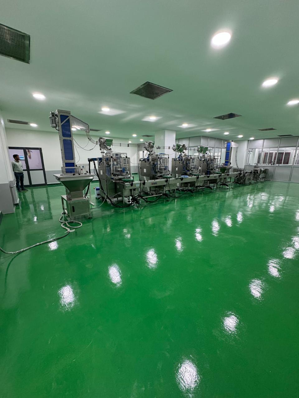Nicotine pouch filling line — eight automated machines in a clean production hall